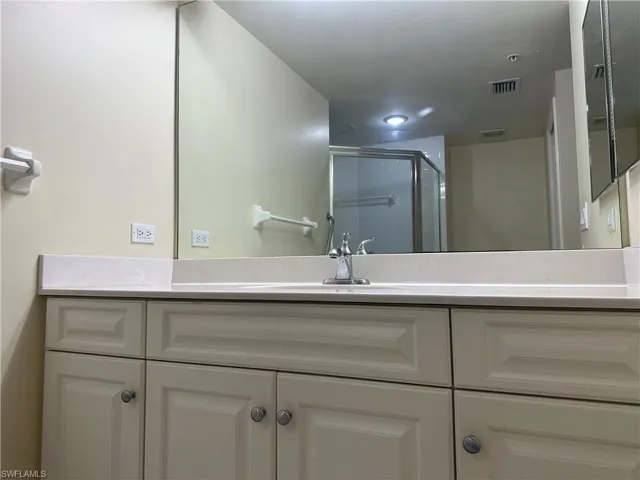 Bathroom featuring walk in shower and vanity