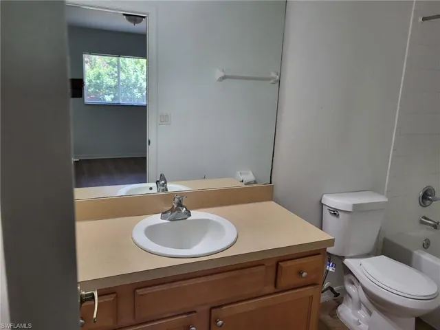 Bathroom with vanity and shower / tub combination