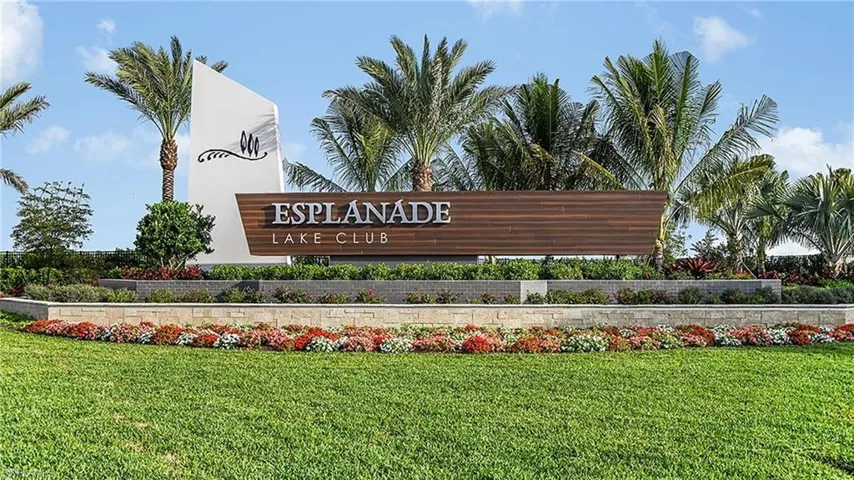 Community / neighborhood sign featuring a yard