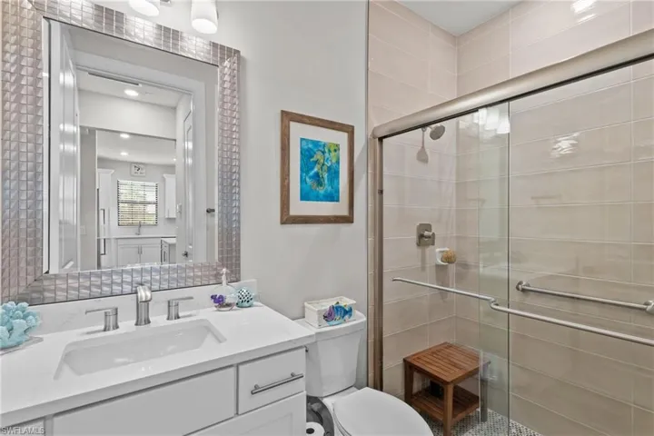 Bathroom featuring vanity and a stall shower