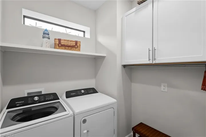 Laundry area featuring cabinet space and washing machine and clothes dryer