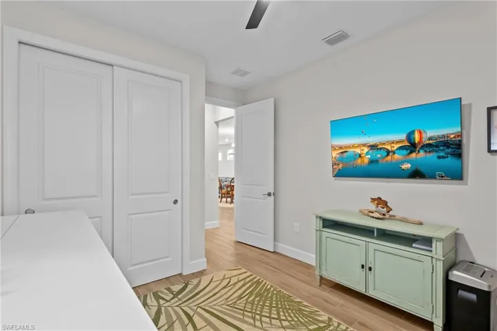 Bedroom featuring a closet, light wood-type flooring, and ceiling fan