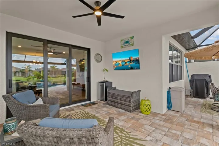 View of patio with grilling area and a ceiling fan