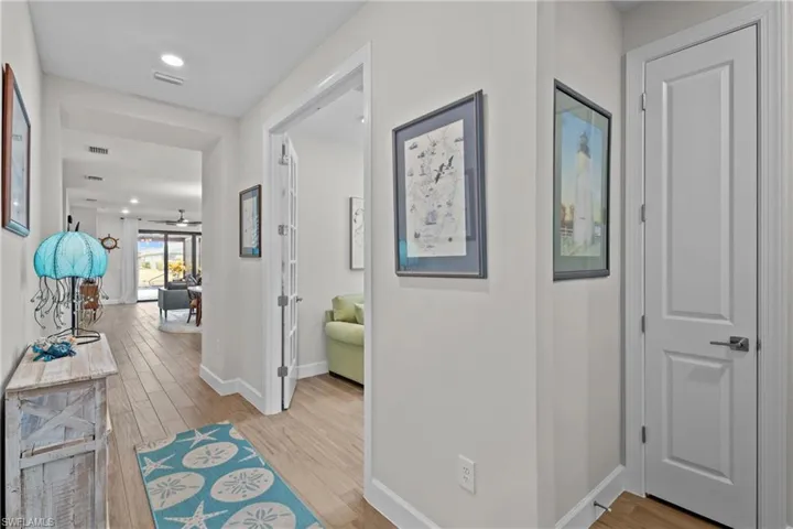 Hall featuring light wood finished floors and recessed lighting