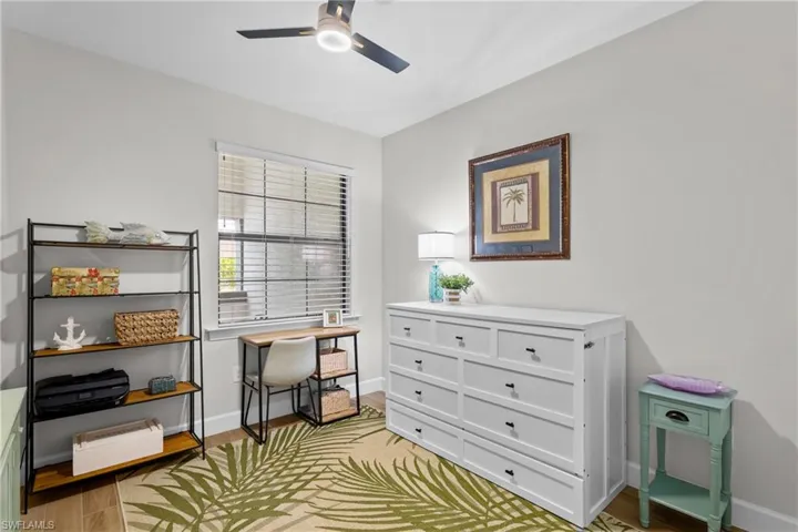 Home office with light wood-style flooring and baseboards