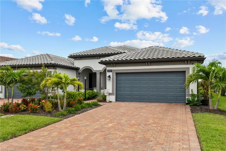 Mediterranean / spanish-style house featuring stucco siding, decorative driveway, an attached garage, and a tiled roof