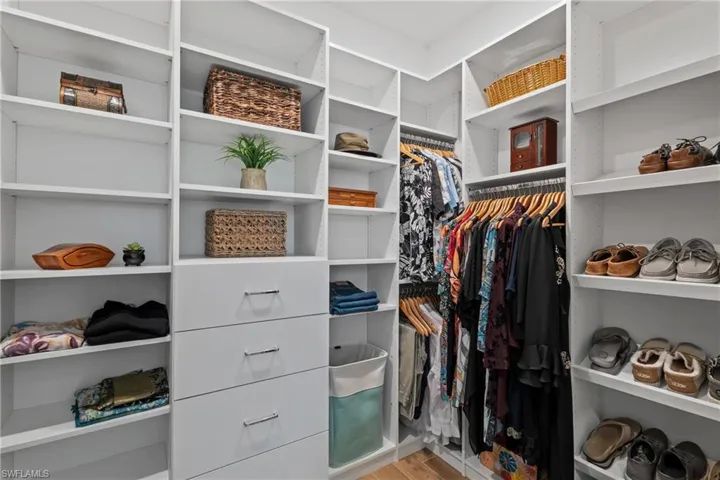 Spacious closet with light wood-style flooring