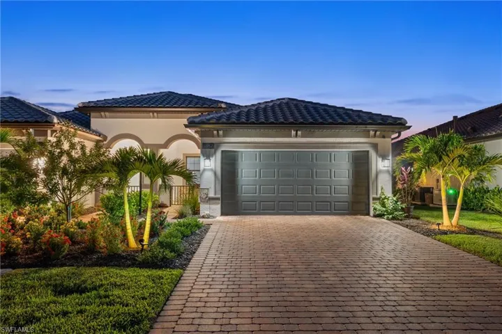 Mediterranean / spanish-style home with decorative driveway, a tile roof, a garage, and stucco siding