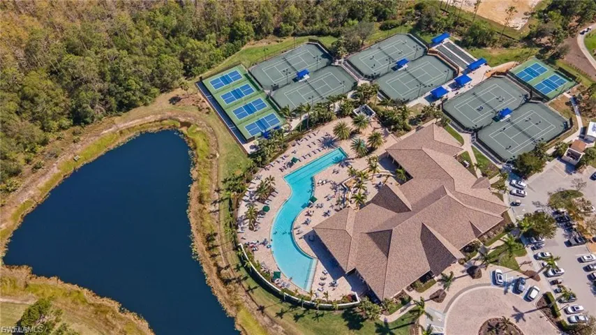 Aerial view of a pool area and a large body of water