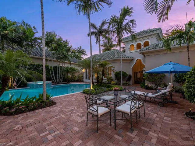 Pool at dusk with a patio area