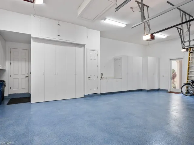 Garage featuring storage cabinets and sink