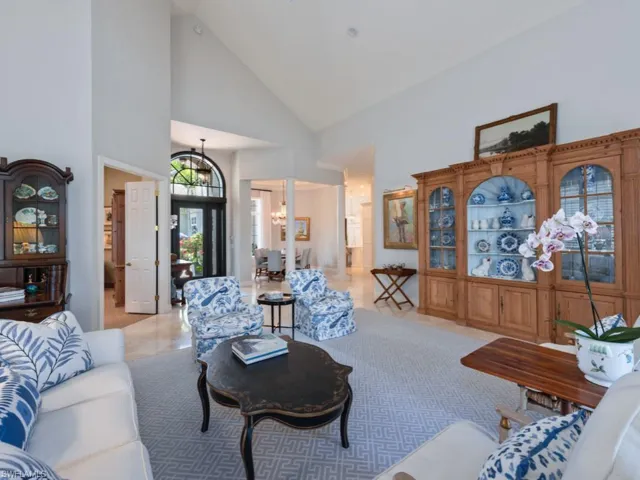 Living room with high vaulted ceiling and a chandelier
