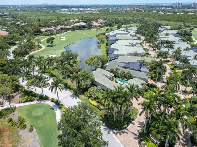 Birds eye view of property with water and golf views