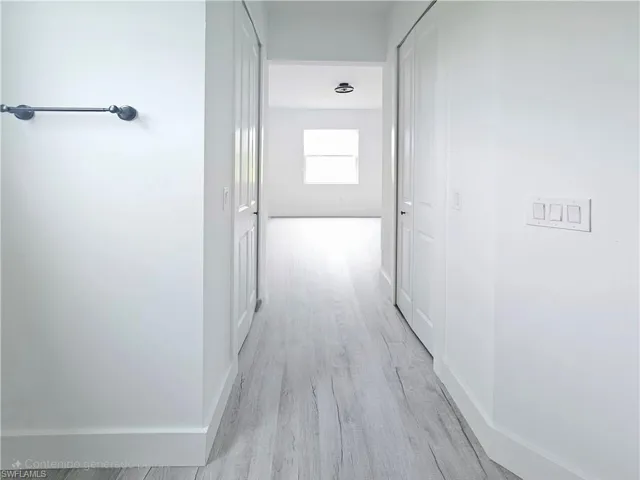 Hall featuring baseboards and light wood-style floors