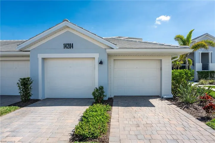 Single story home featuring a tiled roof and stucco siding