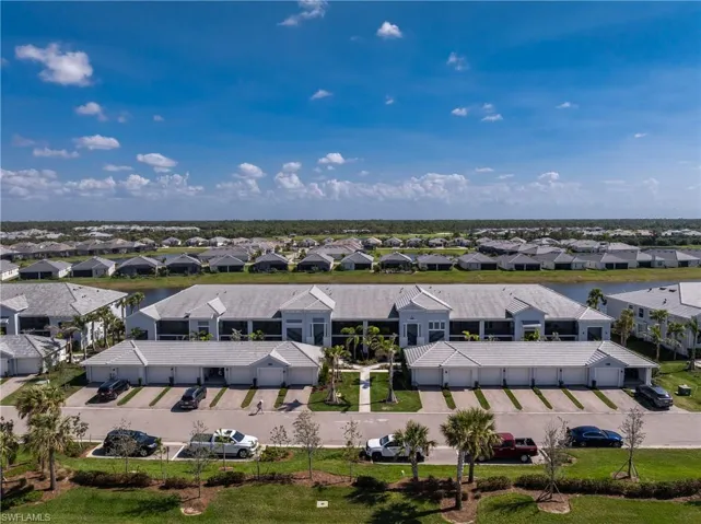 Aerial view of residential area featuring a nearby body of water