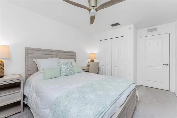 Bedroom with carpet flooring, a ceiling fan, and a closet