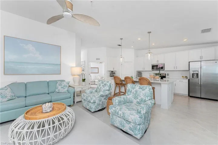 Living area with light tile patterned flooring, recessed lighting, and a ceiling fan