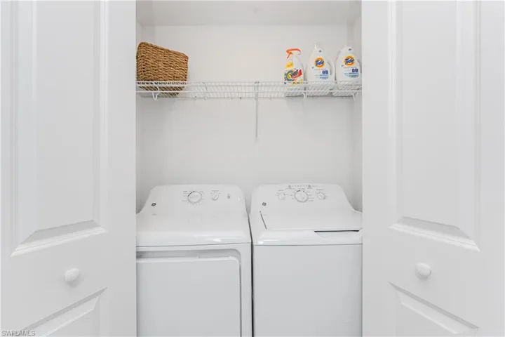 Washroom featuring washing machine and clothes dryer