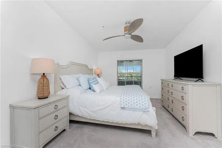 Bedroom with light carpet and ceiling fan