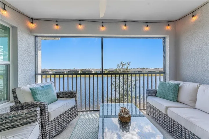Sunroom / solarium with a water view, a residential view, and healthy amount of natural light
