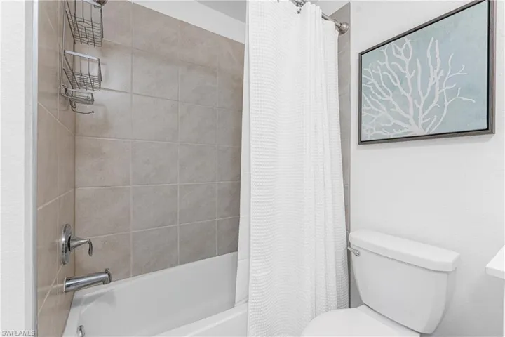 Full bathroom with shower / bath combo and toilet