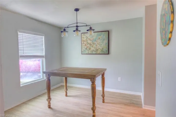 Dining room with light wood-style flooring and baseboards