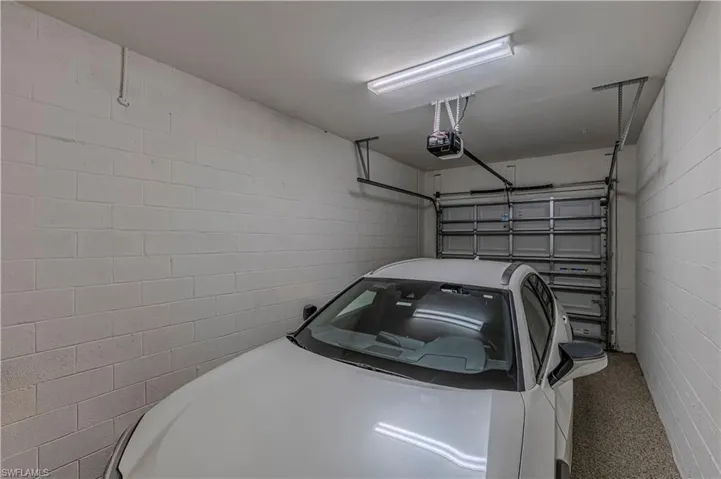 Garage w/ garage door opener & concrete block wall
