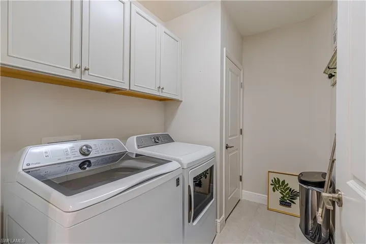 Laundry area w/ cabinet space & washer and dryer