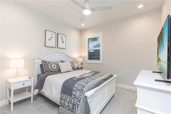 Bedroom featuring ceiling fan, light colored carpet & recessed lighting