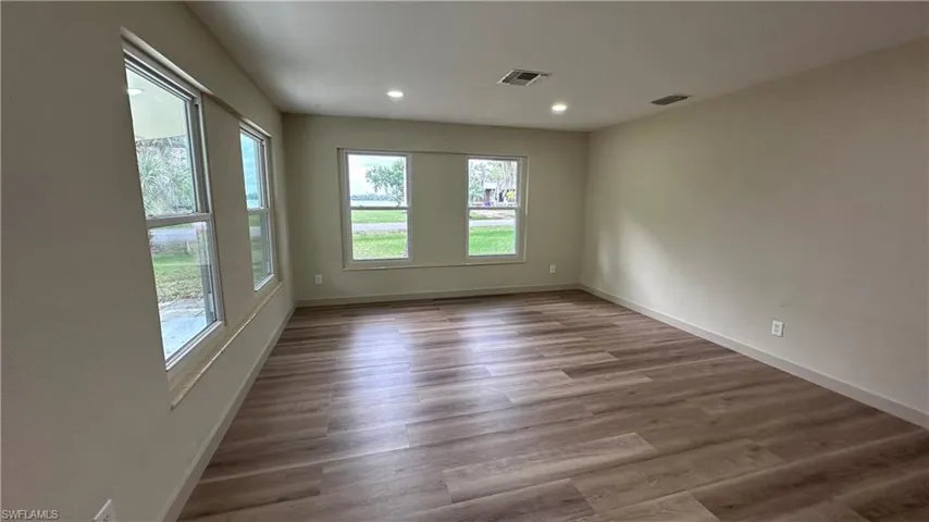 Spare room featuring dark wood finished floors and recessed lighting