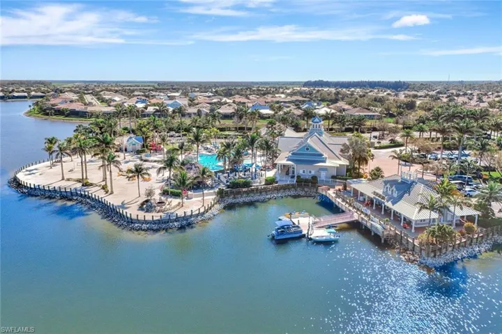 Birds eye view of property with a water view
