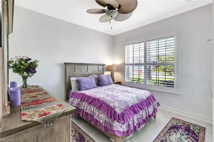 Bedroom with crown molding, baseboards, and ceiling fan