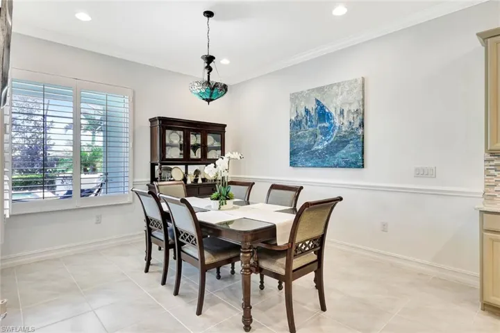 Dining area with baseboards, light tile patterned floors, recessed lighting, and crown molding