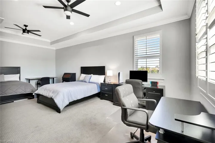 Bedroom with recessed lighting, a raised ceiling, crown molding, and ceiling fan