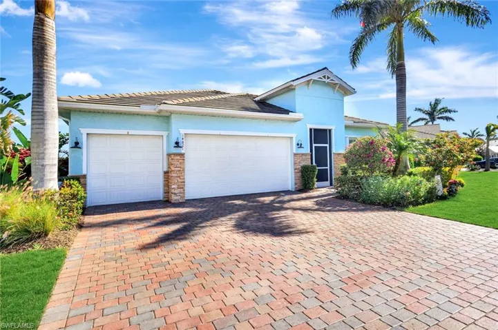 View of front facade with decorative driveway, an attached /Users/chrisevensen/Desktop/Unknown.jpeggarage, and stucco siding