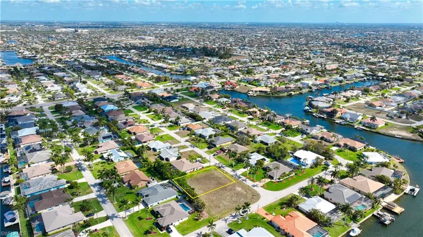Aerial view of residential area featuring a nearby body of water