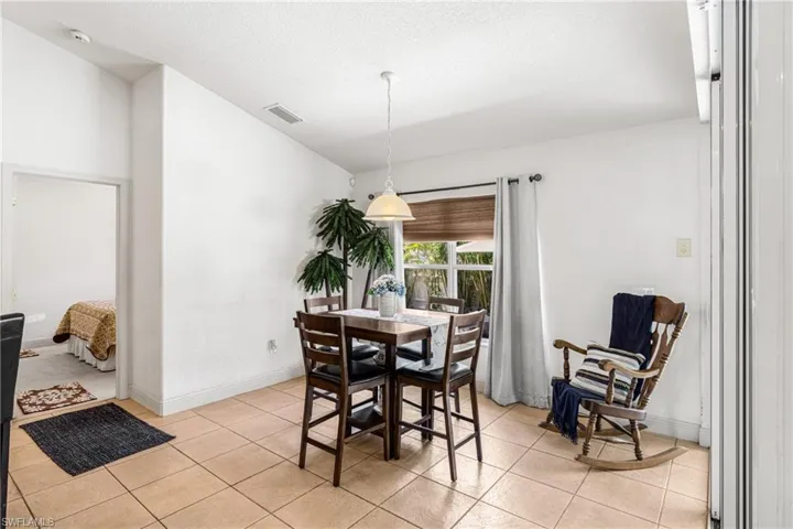 Dining room featuring baseboards, visible vents, and light tile patterned floors