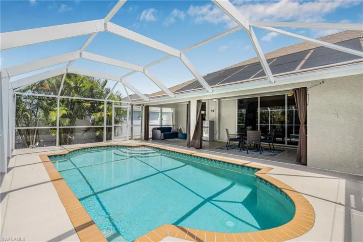 Outdoor pool with glass enclosure and a patio