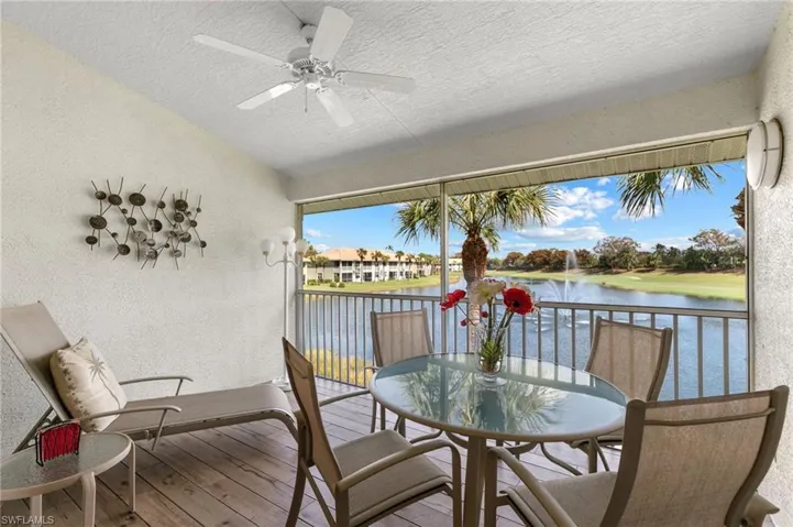 Sunroom featuring a water view and ceiling fan