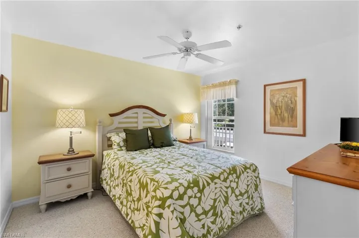 Carpeted bedroom featuring ceiling fan