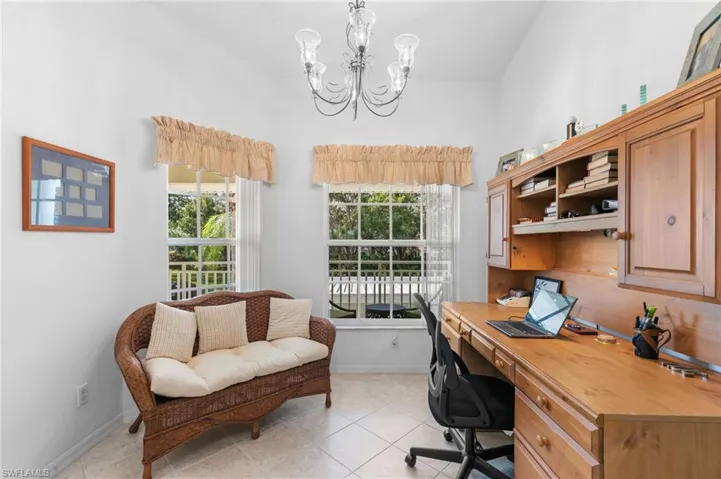 Tiled office with a notable chandelier and plenty of natural light