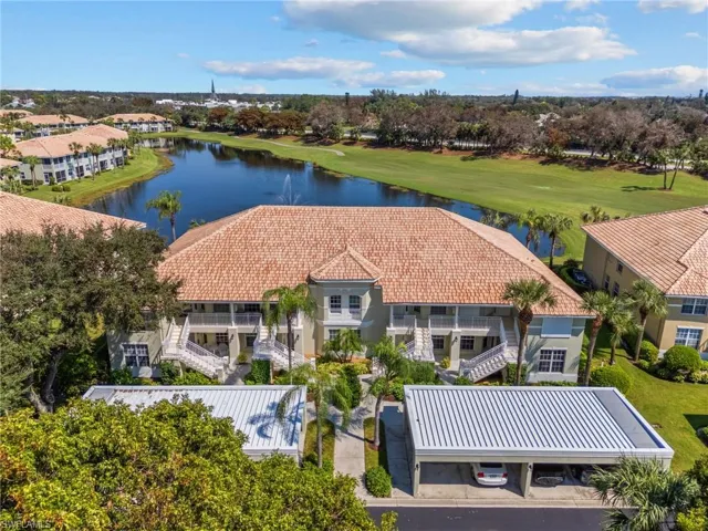 Birds eye view of property with a water view