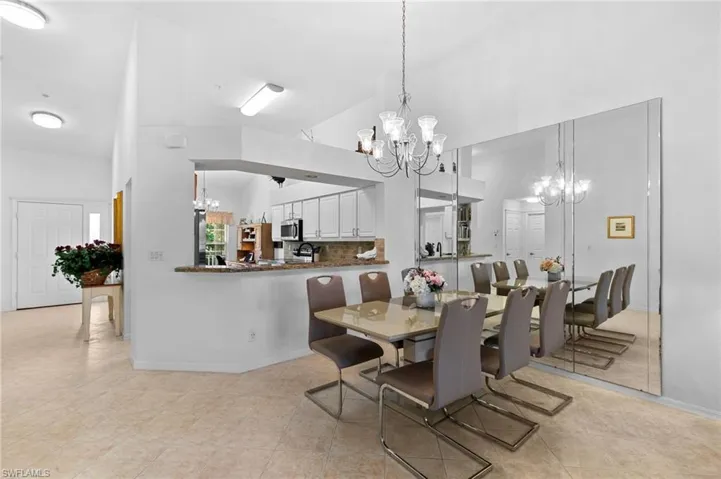 Tiled dining area with high vaulted ceiling