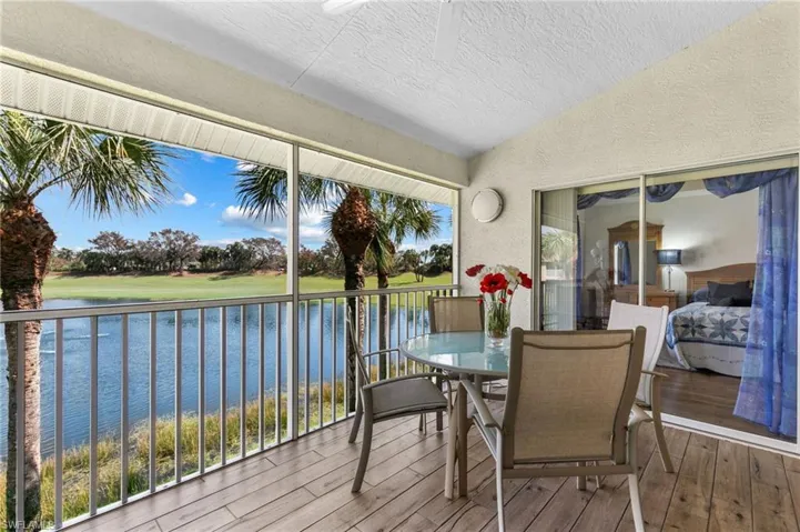 Sunroom / solarium featuring a water view