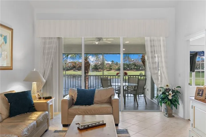Tiled living room featuring ceiling fan