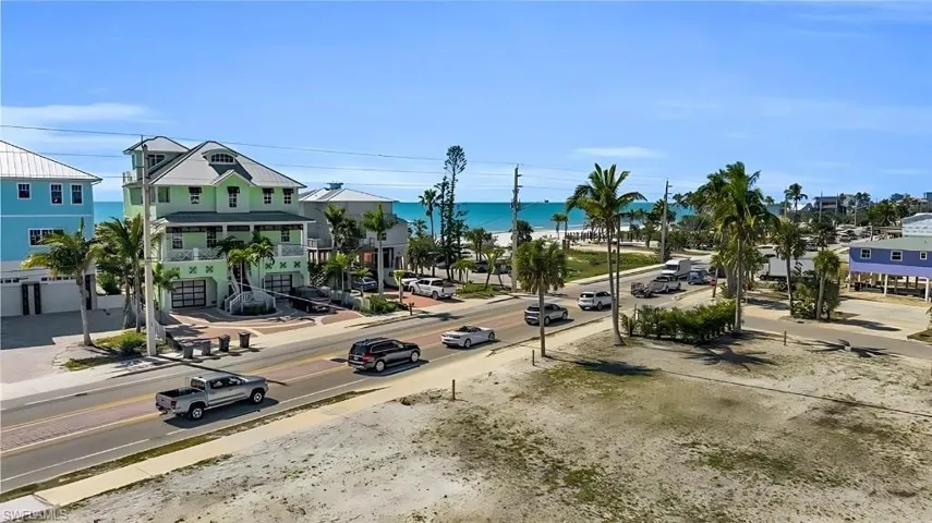 View of road featuring a water view, sidewalks, and curbs VIRTUALLY EDITED