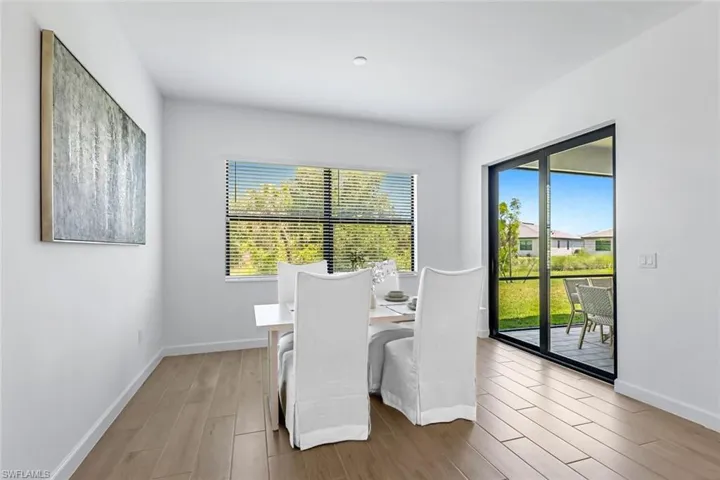 Dining room with a wealth of natural light and wood-type flooring