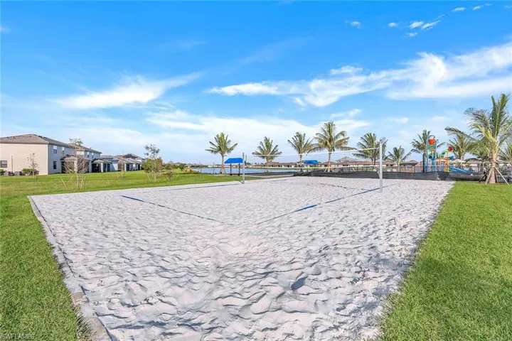 View of home's community with a yard and volleyball court