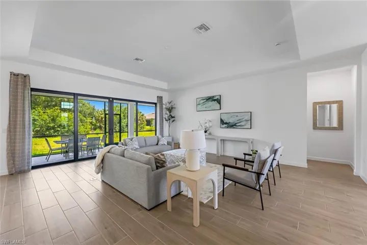 Living room featuring a raised ceiling